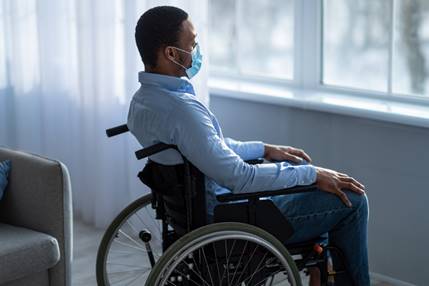 Man in wheelchair by the window - Employment Law